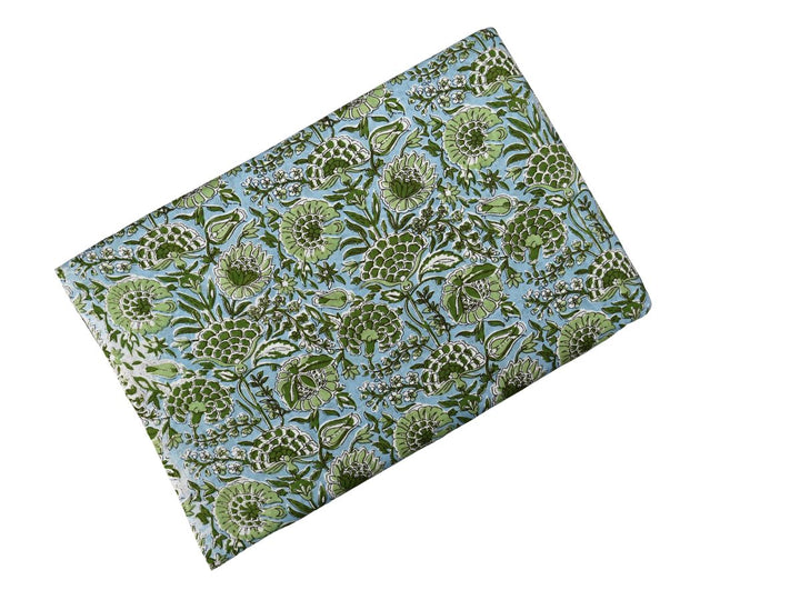 Green floral Indian block print fabric with olive foliage and white accents