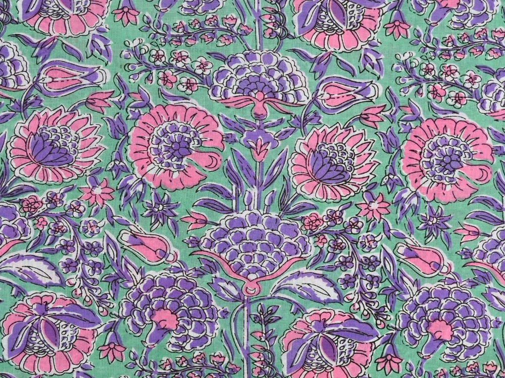 Purple floral cotton fabric by the yard with pink and purple blooms on green