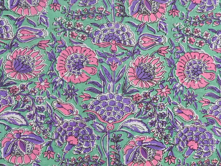 Purple floral cotton fabric by the yard with pink and purple blooms on green