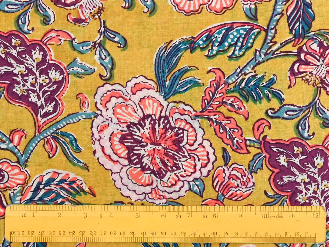 Large-scale floral block print fabric with plum and teal accents