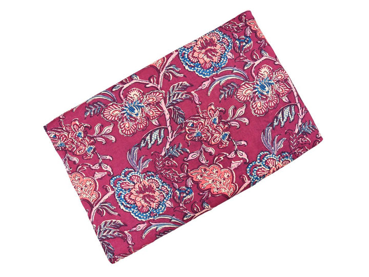 Close-up of burgundy floral cotton fabric with detailed linework and dotted textures