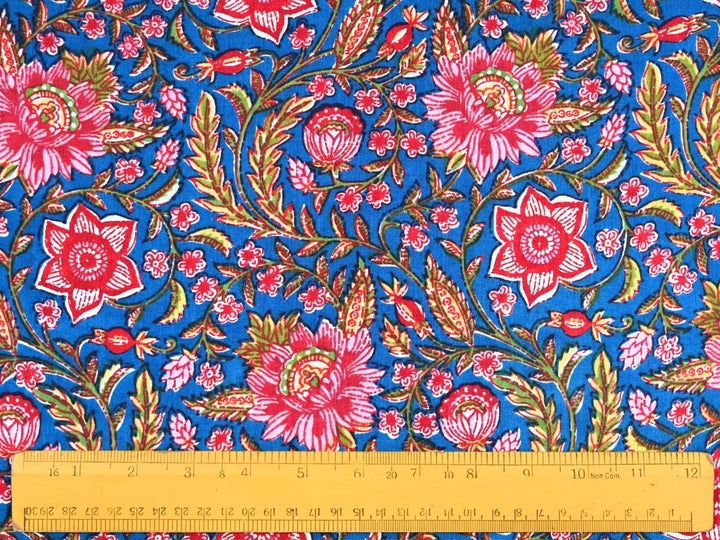 
Close-up of cobalt blue floral cotton fabric with detailed linework and bud details