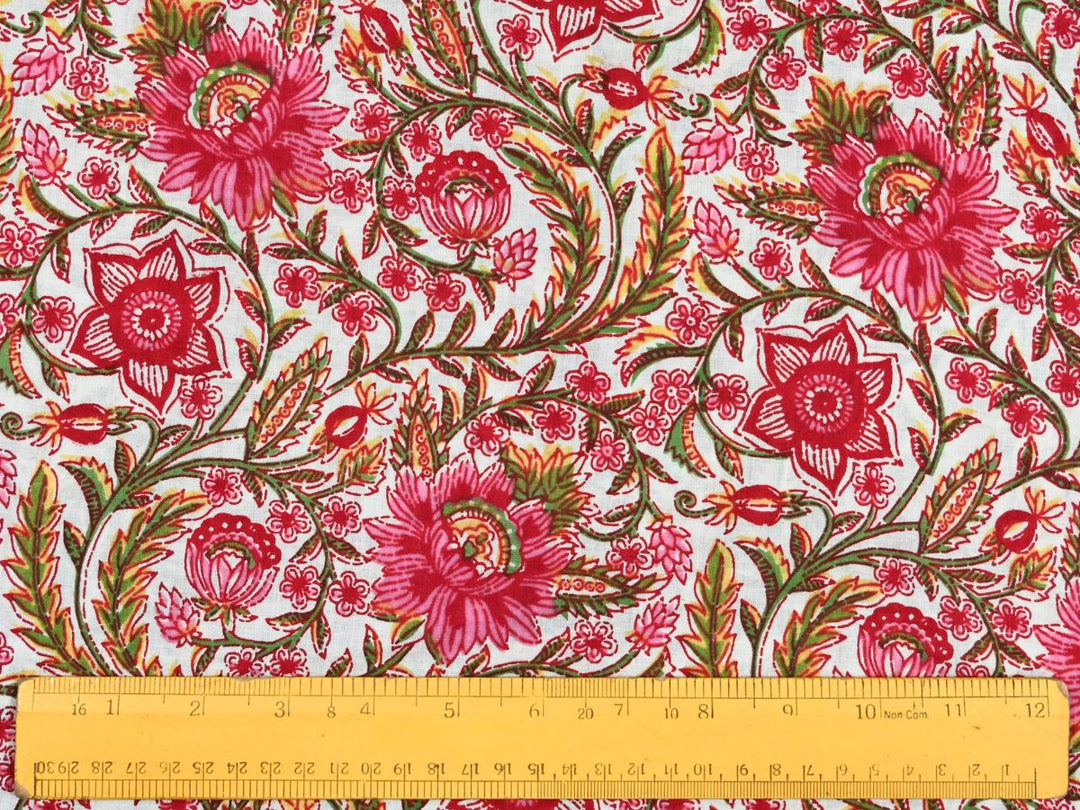 Close-up of red pink floral cotton fabric with detailed linework and bud details