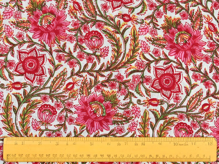 Close-up of red pink floral cotton fabric with detailed linework and bud details