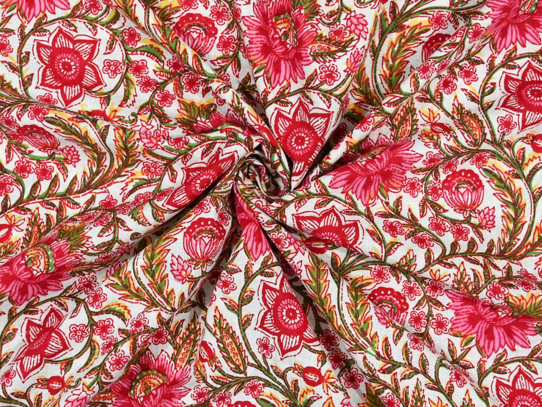 White cotton fabric showing red and pink star-shaped blooms and peony flowers
