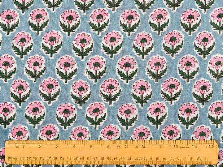 Close-up of grey floral cotton fabric with detailed linework and leafy stems