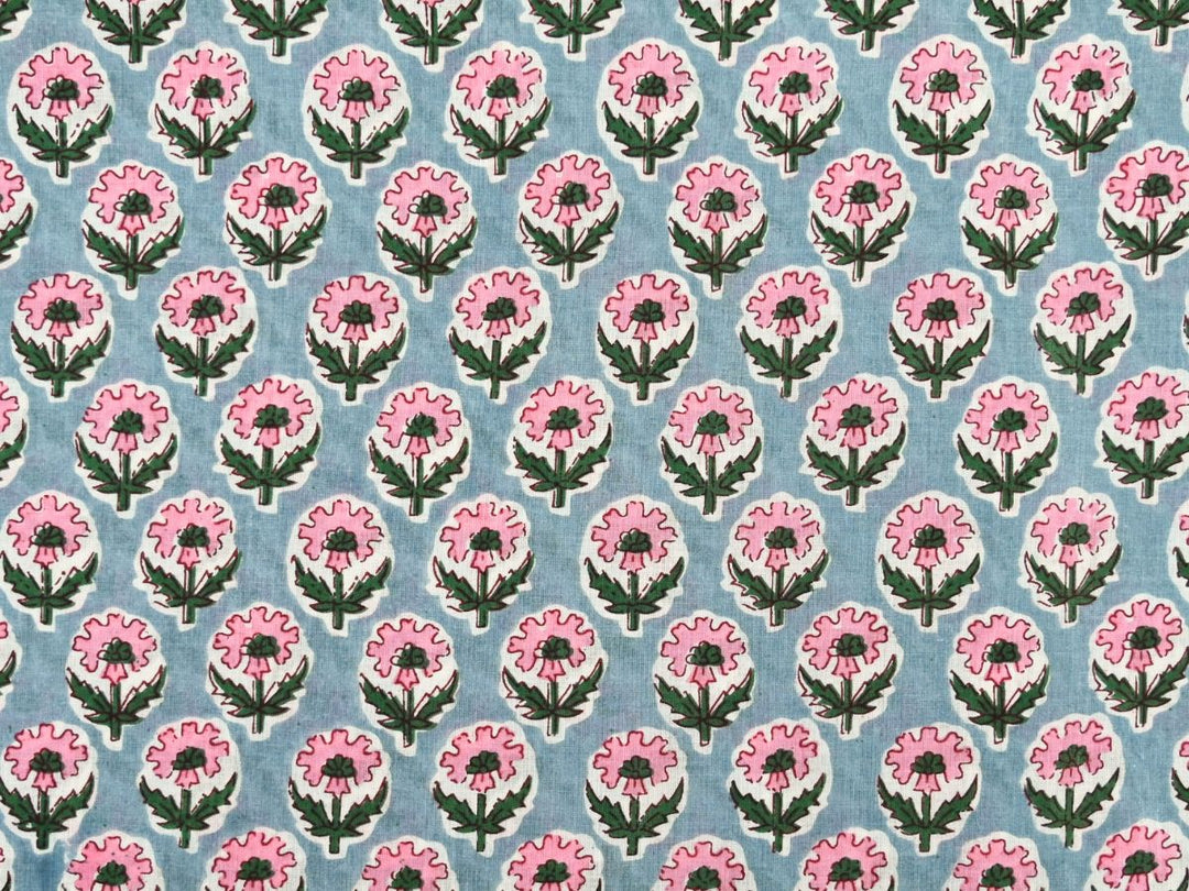 Grey cotton fabric showing pink flowers with green centers and foliage