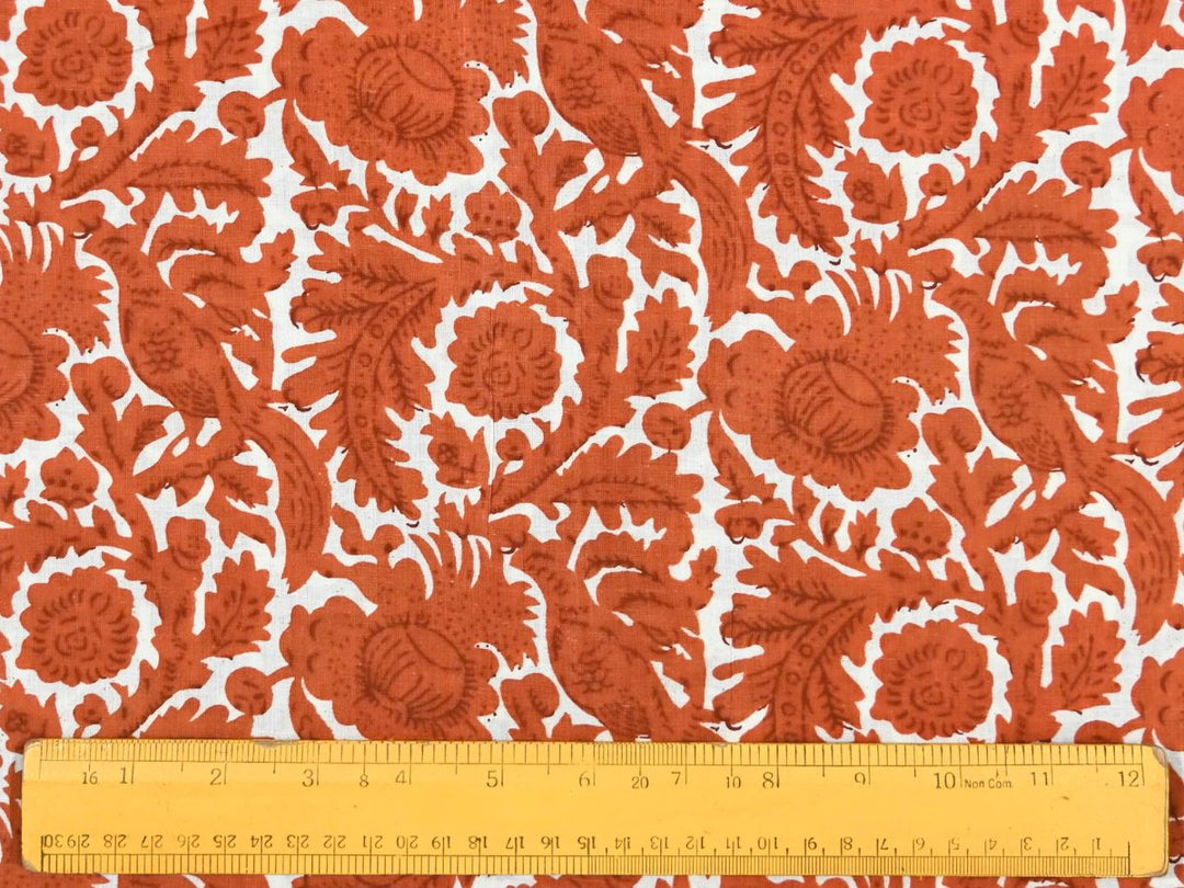 Close-up of brown damask cotton fabric with detailed linework and feathered textures