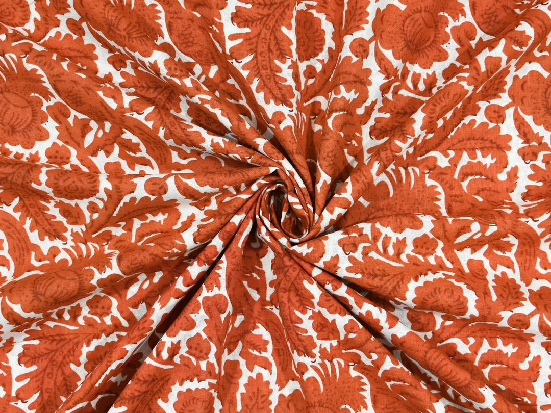 White cotton fabric showing burnt brown peacock birds and floral medallions