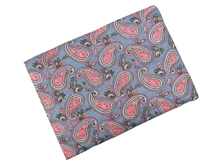 Large-scale paisley block print fabric with green leafy accents
