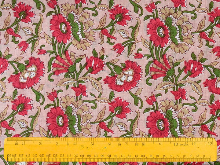 Close-up of red floral cotton fabric with detailed linework and striped petals