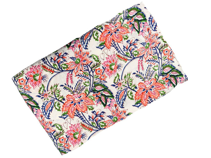 Large-scale floral block print fabric with green leaves and navy branches