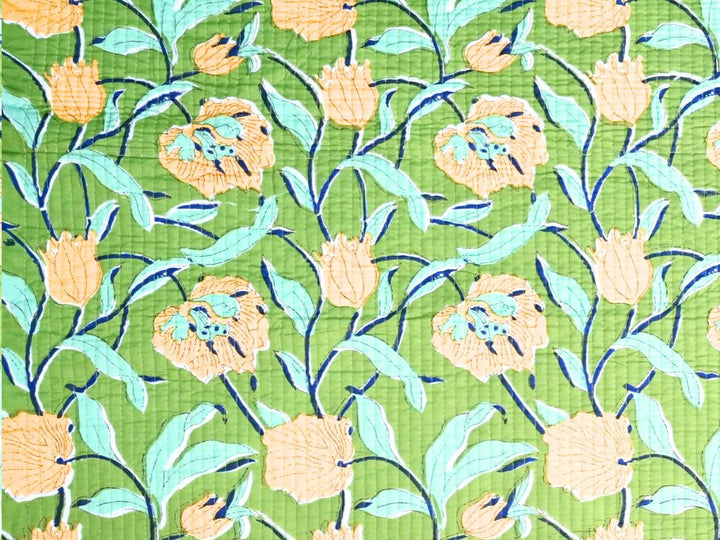 Close-up of quilted floral fabric with mint leaves and navy accents