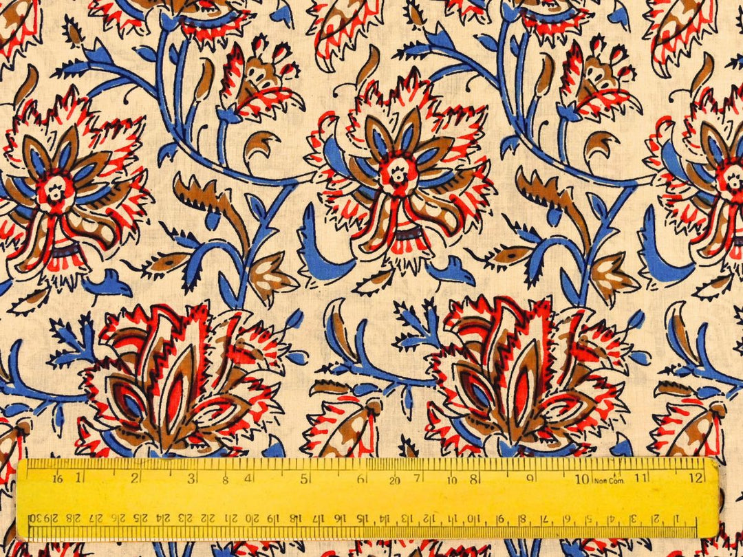 Close-up of cream floral cotton fabric with detailed linework and bud accents
