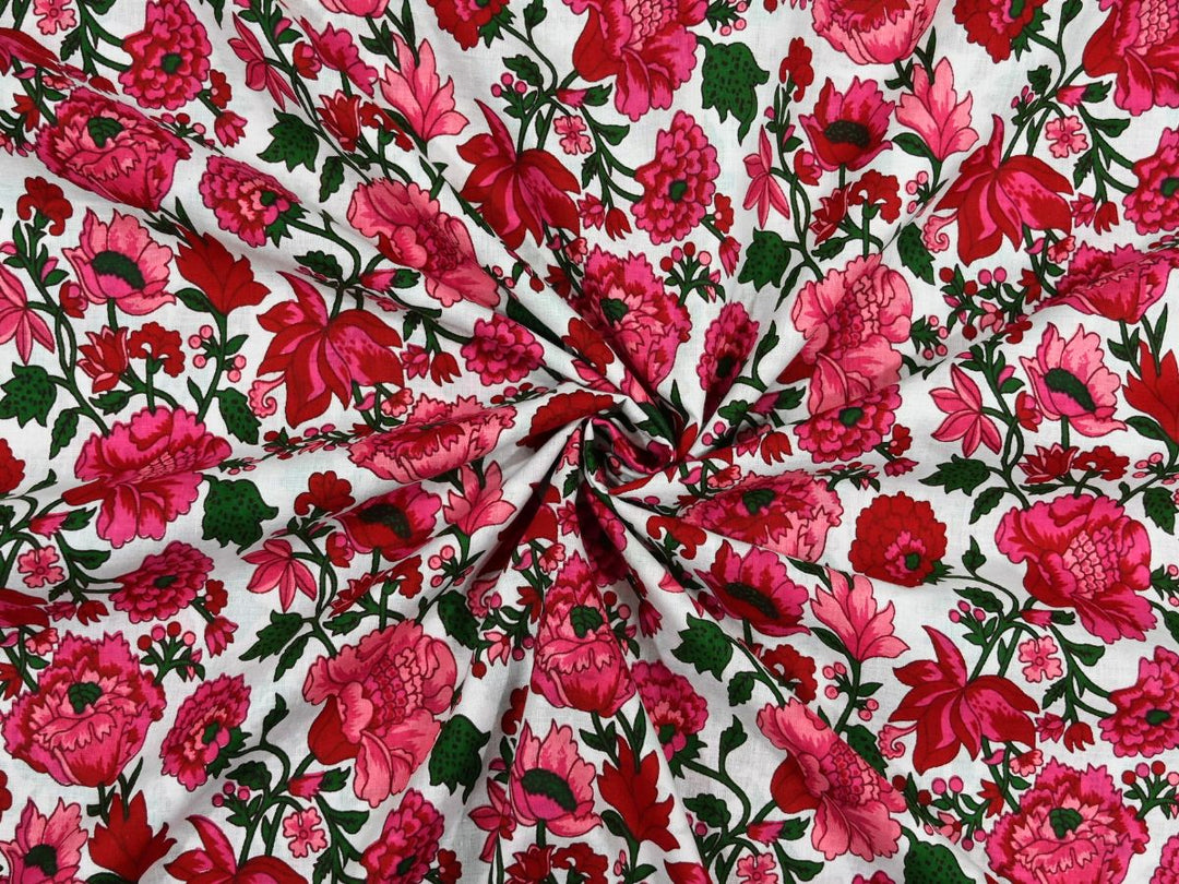 White cotton fabric showing dense fuchsia floral block print