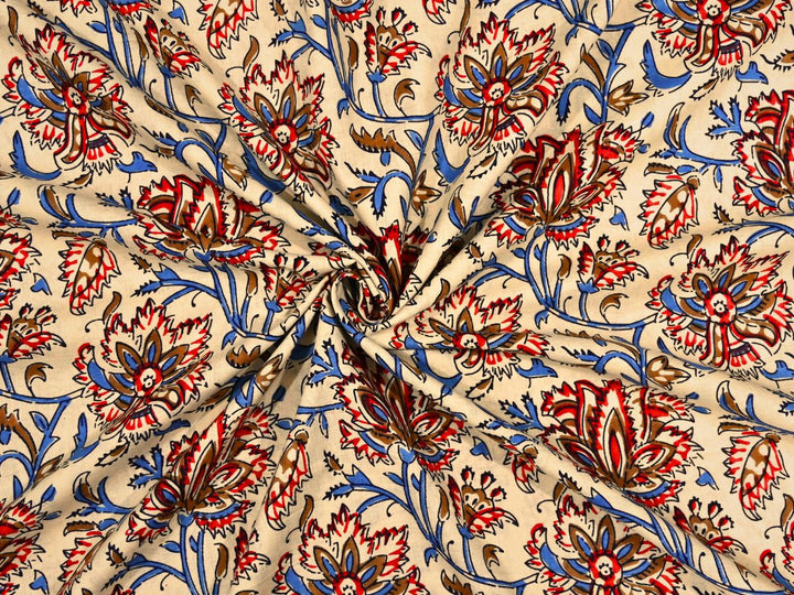Cream cotton fabric showing red and brown blooms with blue vines and leaves