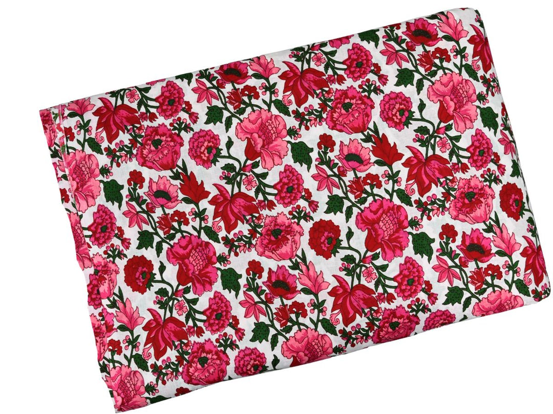 Close-up of fuchsia floral cotton fabric with small pink and red bud details
