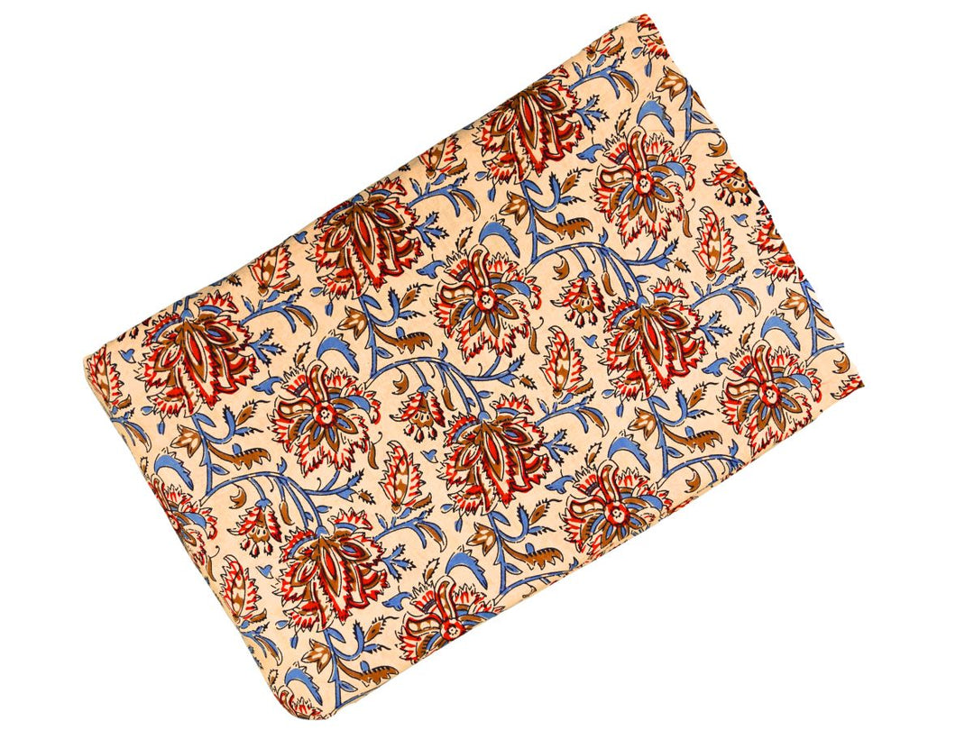 Dense floral block print fabric with warm earth-tone palette on cream ground