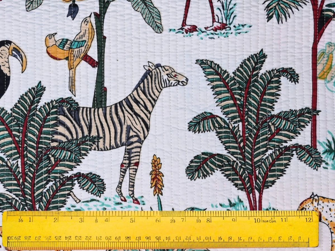 Close-up of tropical jungle quilted fabric with toucan and parrot details