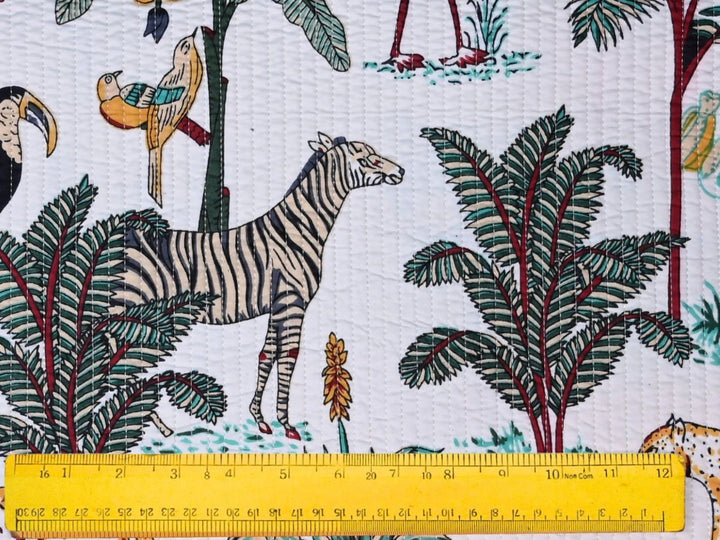 Close-up of tropical jungle quilted fabric with toucan and parrot details