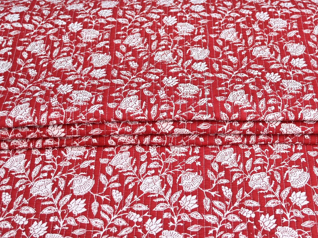 Reversible quilted fabric by the yard with red floral print on one side