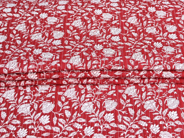 Reversible quilted fabric by the yard with red floral print on one side