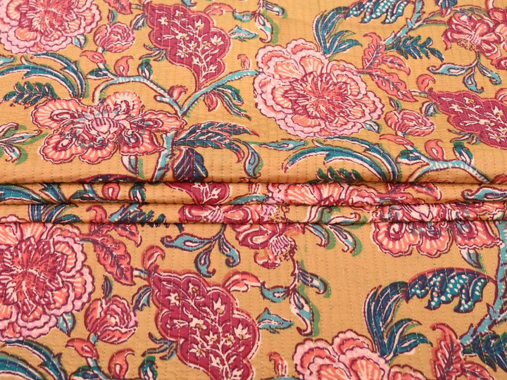 Reversible quilted fabric with orange and white striped reverse