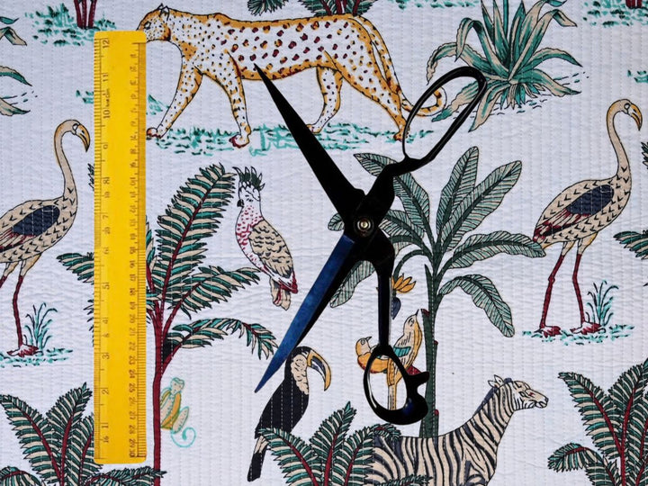 Reversible quilted fabric showing cheetah, flamingo, and palm motifs