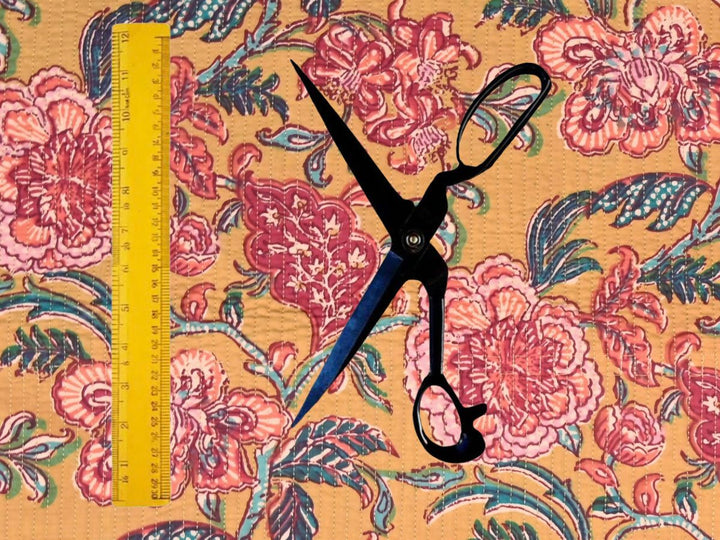 Mustard quilted cotton fabric showing large-scale peony-style flowers