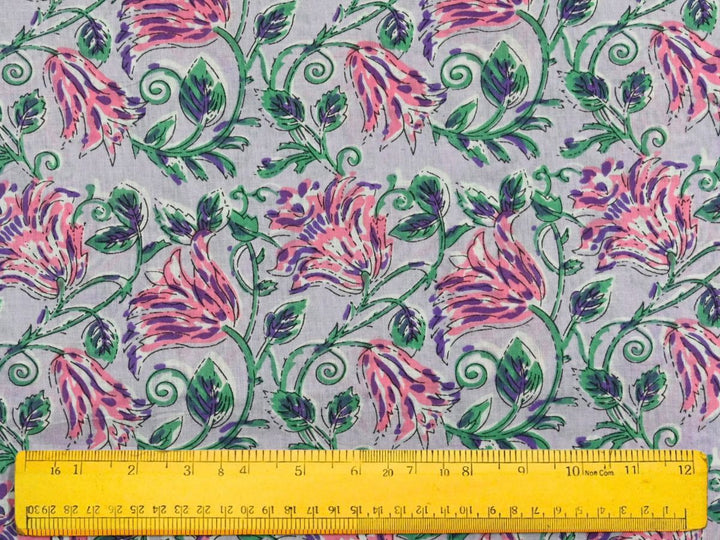 Close-up of lavender floral cotton fabric with detailed linework and bud accents