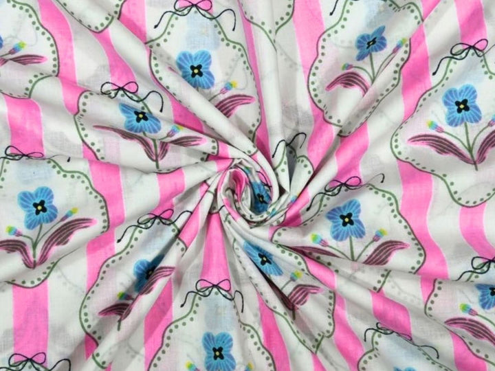 Pink and white striped cotton fabric with blue flowers in scalloped frames