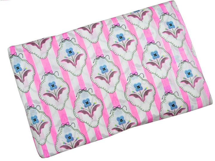 Vintage cottage floral fabric showing whimsical bow accents and dotted borders