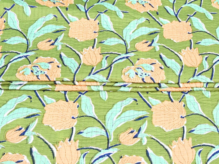 Reversible quilted fabric with yellow and green striped reverse