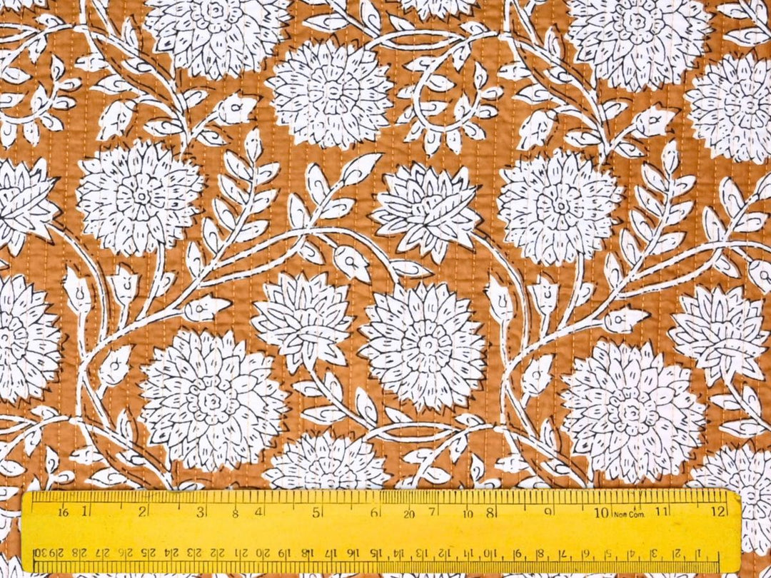 Close-up of quilted floral outline fabric with detailed white linework
