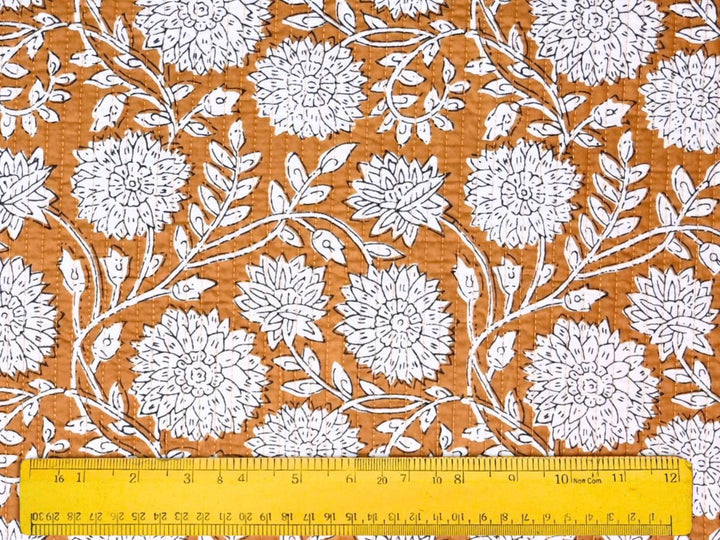Close-up of quilted floral outline fabric with detailed white linework