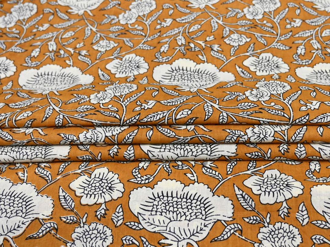 White outline floral fabric on mustard ground with detailed linework
