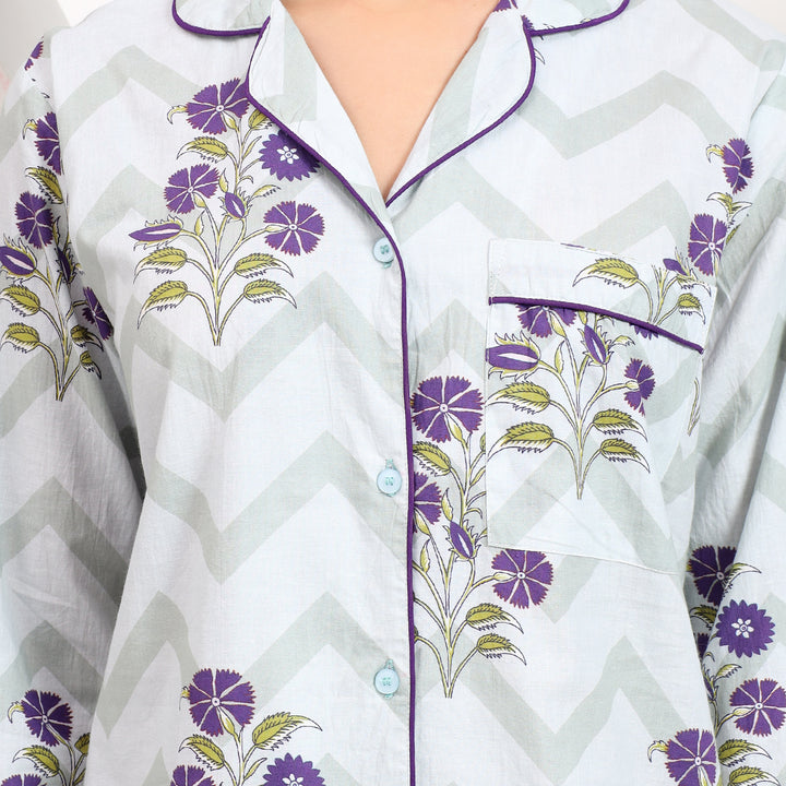 Close-up view of off-white cotton pajama set showing lapel collar and delicate lavender floral print, designed for cozy wear.