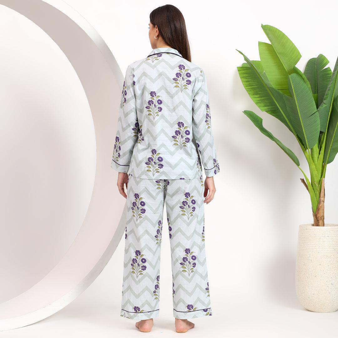 Back view of off-white cotton pajama set with lavender floral handblock print and lapel collar for a comfortable style.