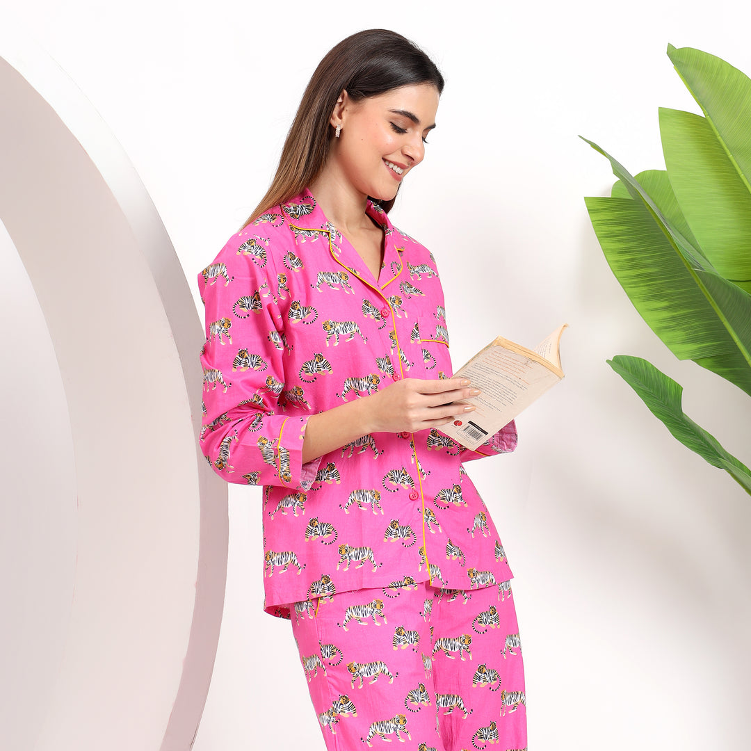 Styling view of pink cotton pajama set with tiger print and lapel collar, offering a chic and cozy fit.