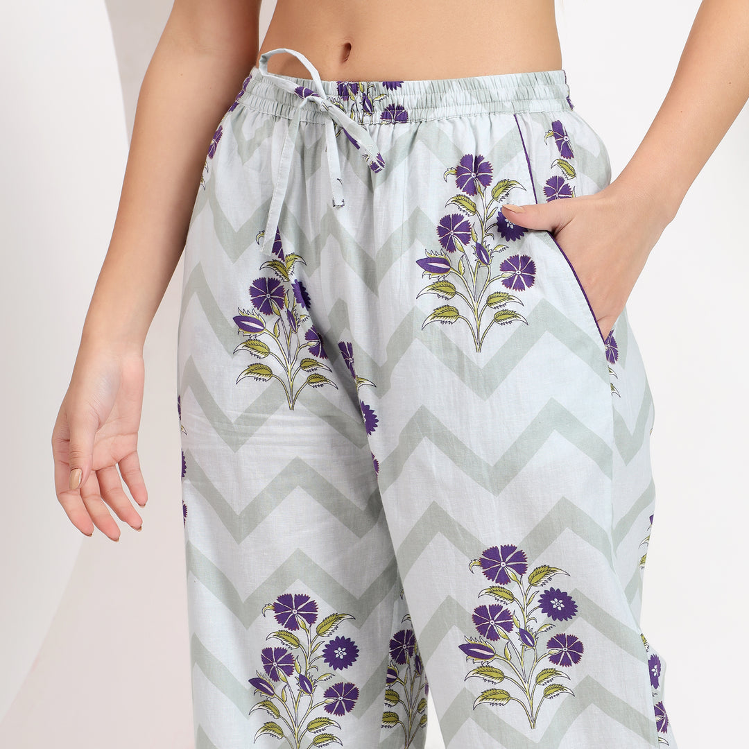 Side pocket view of off-white cotton pajama set with lavender floral print, adding functional elegance to the design.