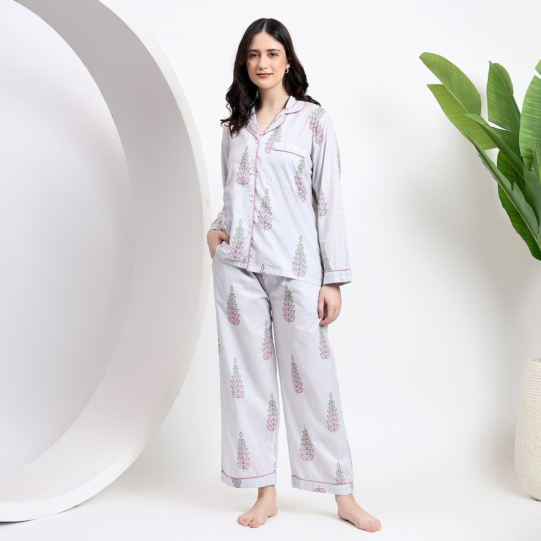 Front view of white cotton pj set with floral handblock print and lapel collar, featuring a stylish front pocket